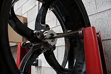 Balancing cones for single-side swinging arm rear wheels